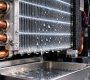 Water droplets condensing on the cold heat sink of a cabinet dehumidifier, showing how dehumidifiers work